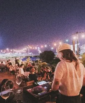 DJ on a rooftop at Le Café des Stagiaires